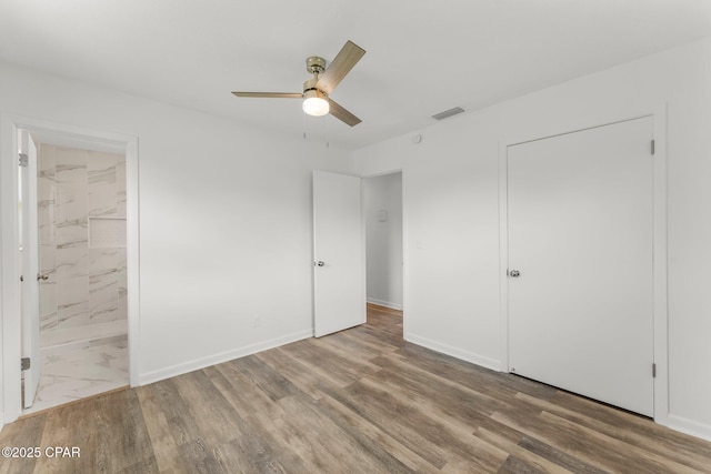2020 Greenbriar Blvd, Lynn Haven, FL 32444 - unfurnished bedroom with wood finished floors, ensuite bathroom, and ceiling fan