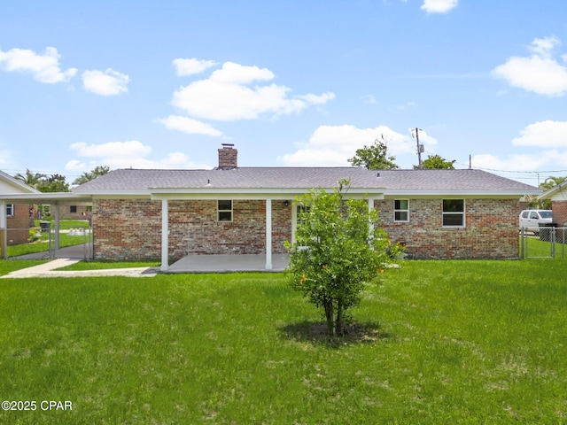 2020 Greenbriar Blvd, Lynn Haven, FL 32444 - back of property with a gate, a patio area, a chimney, and brick siding