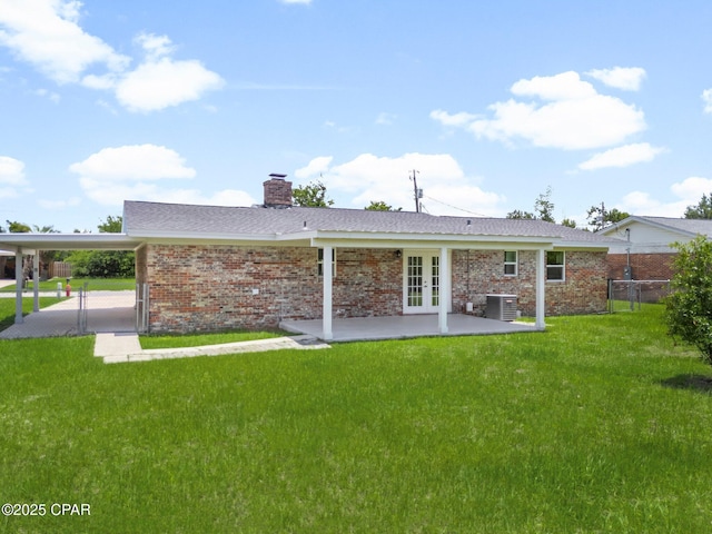2020 Greenbriar Blvd, Lynn Haven, FL 32444 - rear view of property featuring french doors, an attached carport, a chimney, and brick siding