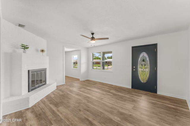 2020 Greenbriar Blvd, Lynn Haven, FL 32444 - unfurnished living room featuring a ceiling fan, a brick fireplace, and wood finished floors