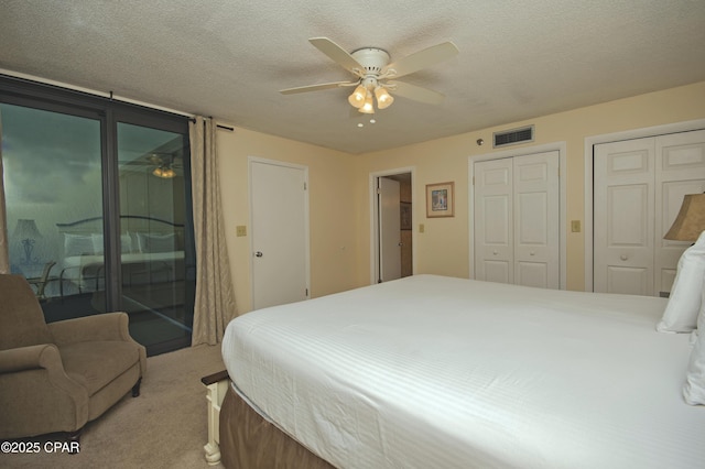6201 Thomas Dr Unit 1005, Panama City Beach, FL 32408 - carpeted bedroom with access to exterior, two closets, ceiling fan, and a textured ceiling