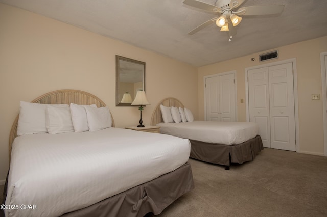 6201 Thomas Dr Unit 1005, Panama City Beach, FL 32408 - carpeted bedroom featuring ceiling fan and two closets