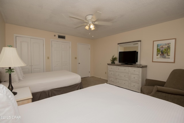 6201 Thomas Dr Unit 1005, Panama City Beach, FL 32408 - carpeted bedroom with a ceiling fan and two closets
