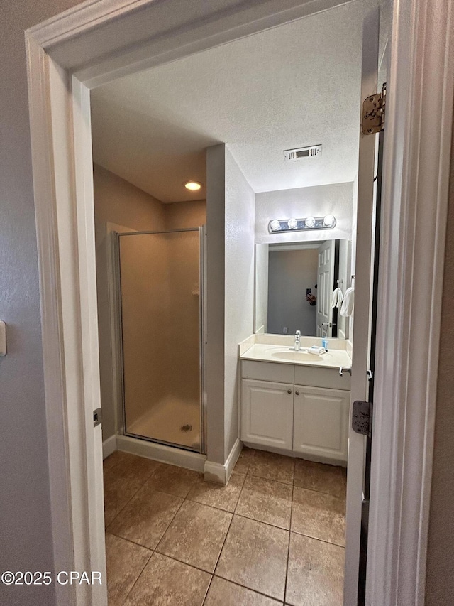 16819 Front Beach Rd Unit 107, Panama City Beach, FL 32413 - full bath with tile patterned floors, vanity, and a shower stall
