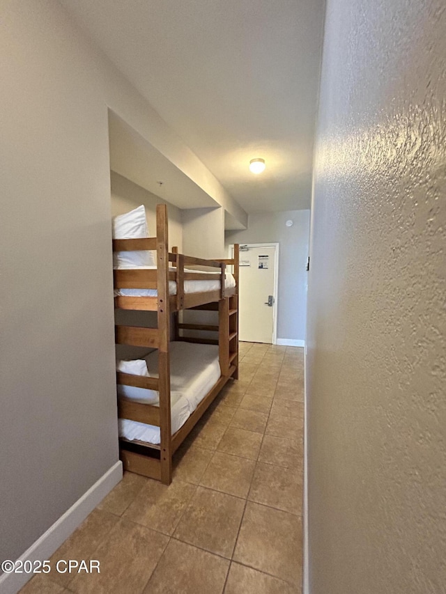 16819 Front Beach Rd Unit 107, Panama City Beach, FL 32413 - hallway featuring tile patterned floors and a textured wall