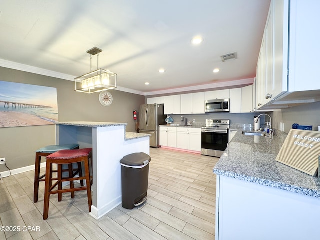 2816 N Panama Ave Unit A & B, Panama City, FL 32405 - kitchen with appliances with stainless steel finishes, crown molding, wood finish floors, recessed lighting, and white cabinets
