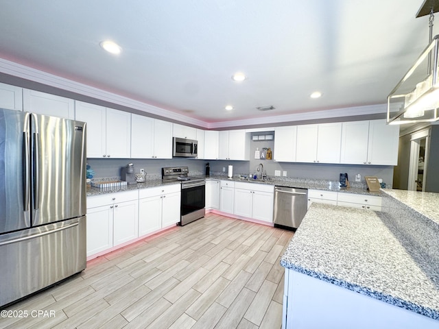 2816 N Panama Ave Unit A & B, Panama City, FL 32405 - kitchen featuring appliances with stainless steel finishes, light wood-style flooring, white cabinetry, light stone countertops, and recessed lighting
