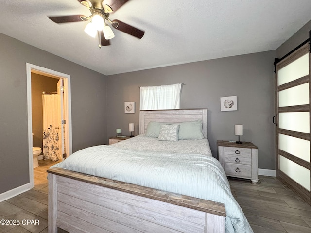 2816 N Panama Ave Unit A & B, Panama City, FL 32405 - bedroom with wood finished floors, a barn door, ensuite bath, and a ceiling fan