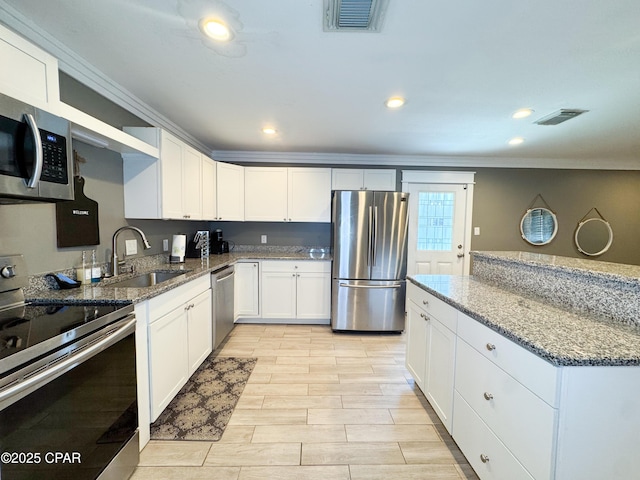 2816 N Panama Ave Unit A & B, Panama City, FL 32405 - kitchen featuring stainless steel appliances, crown molding, stone counters, white cabinetry, and recessed lighting