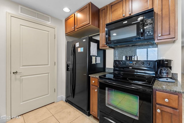 16701 Front Beach Rd Unit 805, Panama City Beach, FL 32413 - kitchen featuring black appliances, brown cabinets, light tile patterned flooring, decorative backsplash, and stone countertops