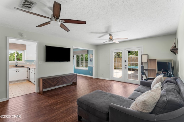 4004 E 7th Cir, Panama City, FL 32404 - living area with ceiling fan, french doors, wood finished floors, and a textured ceiling