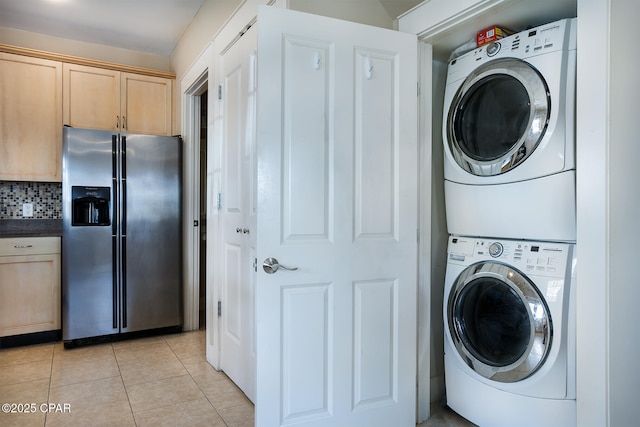 8410 Thomas Dr Unit 1, Panama City Beach, FL 32408 - laundry room with stacked washing machine and dryer and light tile patterned floors