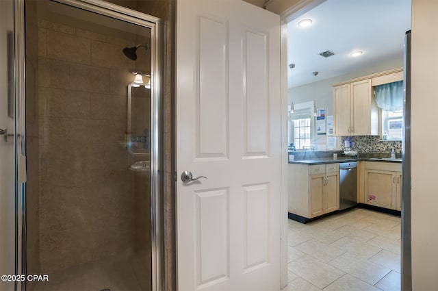 8410 Thomas Dr Unit 1, Panama City Beach, FL 32408 - bathroom with a shower stall, vanity, backsplash, tile patterned flooring, and recessed lighting
