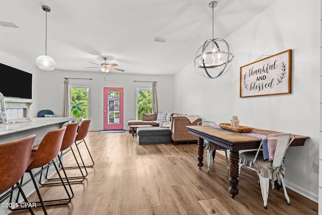 406 Raven Ln, Panama City, FL 32404 - dining space featuring light wood-style floors, a chandelier, and a ceiling fan