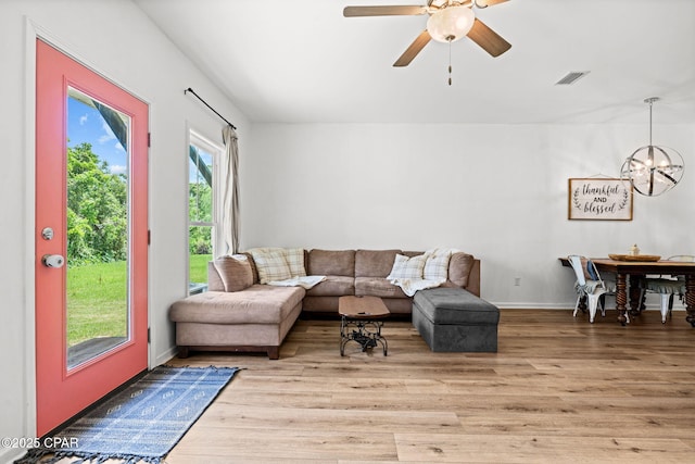 406 Raven Ln, Panama City, FL 32404 - living room with a chandelier, wood finished floors, and a ceiling fan