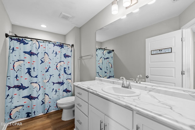 406 Raven Ln, Panama City, FL 32404 - full bathroom with vanity, wood finished floors, a shower with shower curtain, and recessed lighting
