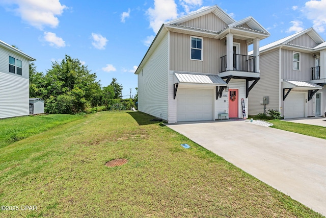 406 Raven Ln, Panama City, FL 32404 - view of front facade with a garage, driveway, a front lawn, board and batten siding, and a balcony
