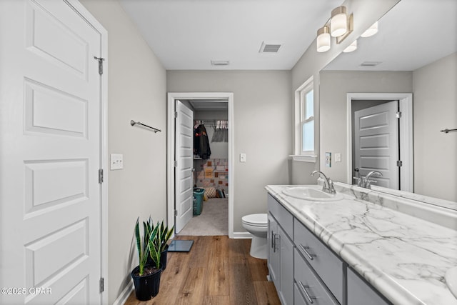 406 Raven Ln, Panama City, FL 32404 - bathroom with vanity, wood finished floors, and a spacious closet