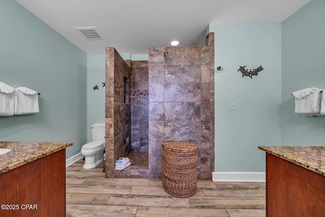 4100 Marriott Dr Unit 402, Panama City Beach, FL 32408 - bathroom with vanity, wood tiled floors, and walk in shower