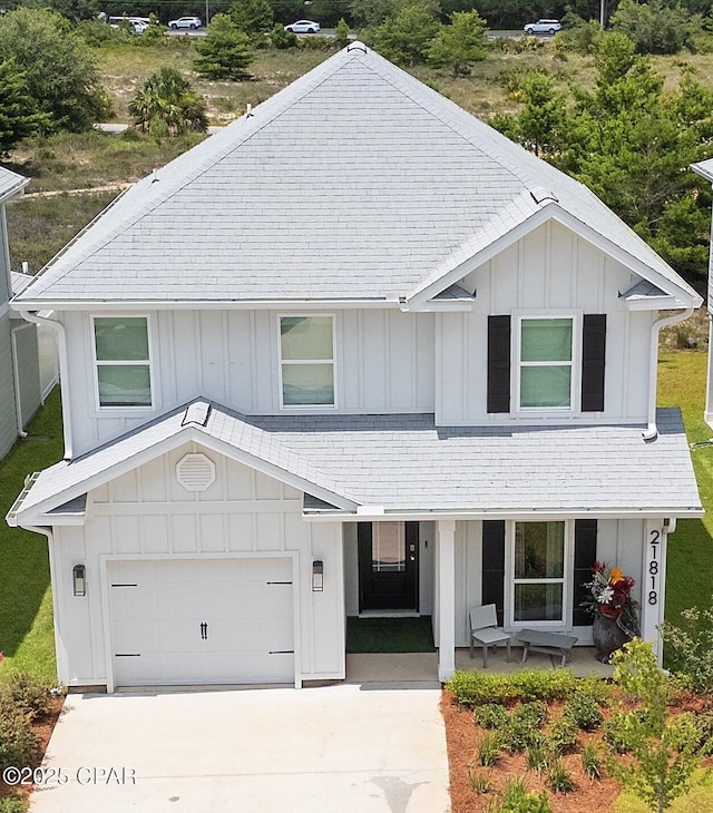 21818 Kelly Pines Pl, Panama City Beach, FL 32413 - view of front of property featuring a porch, board and batten siding, concrete driveway, and a garage