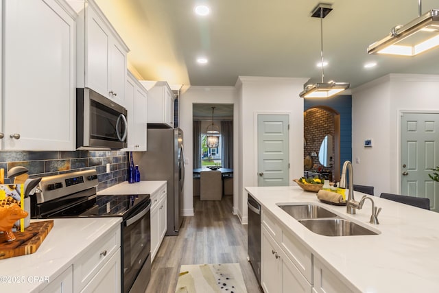21818 Kelly Pines Pl, Panama City Beach, FL 32413 - kitchen featuring stainless steel appliances, ornamental molding, light wood finished floors, recessed lighting, and decorative backsplash