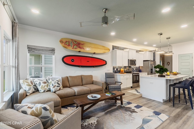 21818 Kelly Pines Pl, Panama City Beach, FL 32413 - living area featuring ornamental molding, ceiling fan, light wood-style floors, and recessed lighting