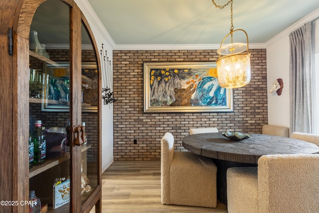 21818 Kelly Pines Pl, Panama City Beach, FL 32413 - dining area with brick wall, wood finished floors, and crown molding