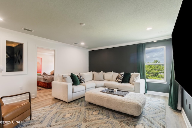 21818 Kelly Pines Pl, Panama City Beach, FL 32413 - living area featuring light wood-style floors, recessed lighting, and a textured ceiling