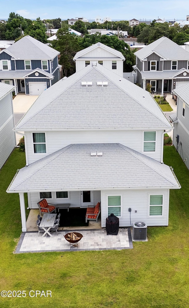 21818 Kelly Pines Pl, Panama City Beach, FL 32413 - rear view of house with an outdoor fire pit, a patio area, a yard, and a residential view
