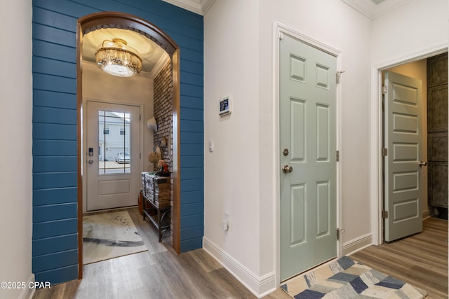 21818 Kelly Pines Pl, Panama City Beach, FL 32413 - foyer featuring crown molding, wood finished floors, and arched walkways