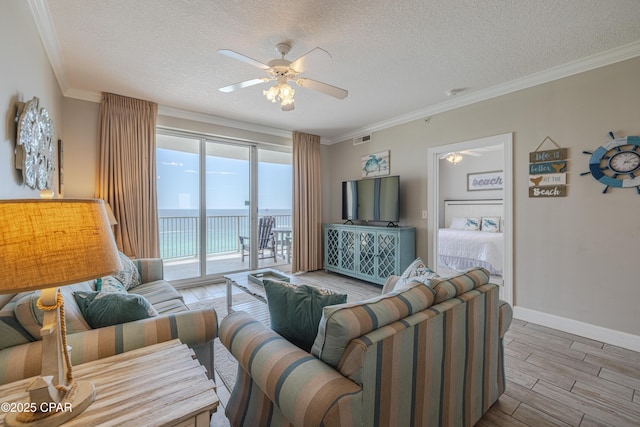 10625 Front Beach Rd Unit 1102, Panama City Beach, FL 32407 - living room featuring ceiling fan, a textured ceiling, wood finished floors, and crown molding