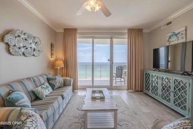 10625 Front Beach Rd Unit 1102, Panama City Beach, FL 32407 - living area featuring a textured ceiling, light wood finished floors, crown molding, and ceiling fan