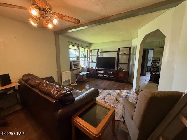 2735 E 12th St, Panama City, FL 32401 - living area featuring wood finished floors, ceiling fan, arched walkways, and cooling unit