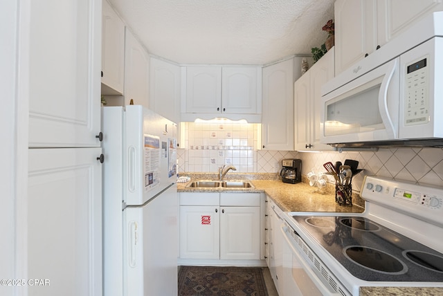 8743 Thomas Dr Unit 928, Panama City Beach, FL 32408 - kitchen with white appliances, decorative backsplash, white cabinets, light countertops, and a textured ceiling