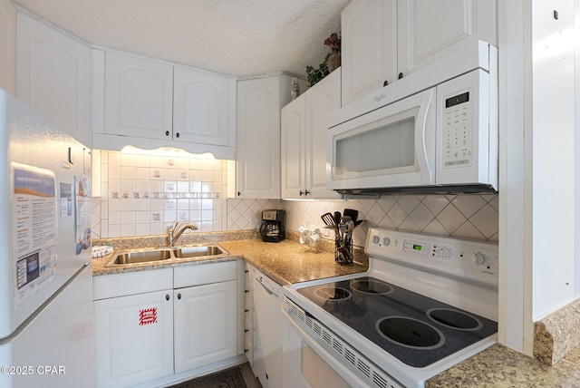 8743 Thomas Dr Unit 928, Panama City Beach, FL 32408 - kitchen with white appliances, white cabinetry, decorative backsplash, light countertops, and a textured ceiling