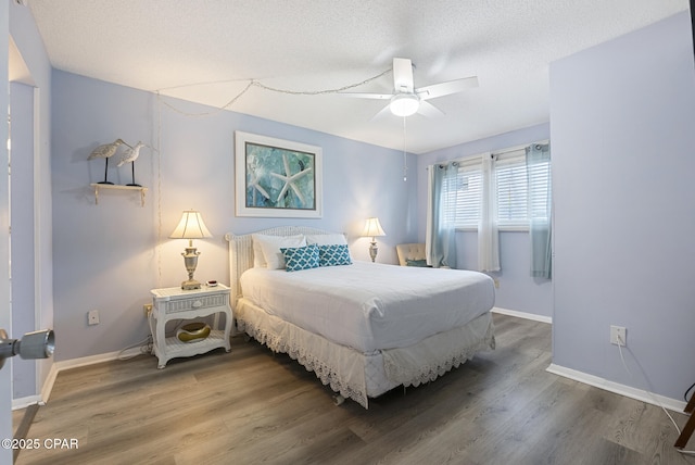8743 Thomas Dr Unit 928, Panama City Beach, FL 32408 - bedroom featuring wood finished floors, a ceiling fan, and a textured ceiling