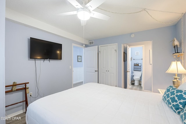 8743 Thomas Dr Unit 928, Panama City Beach, FL 32408 - bedroom featuring wood finished floors, a closet, a ceiling fan, and ensuite bathroom