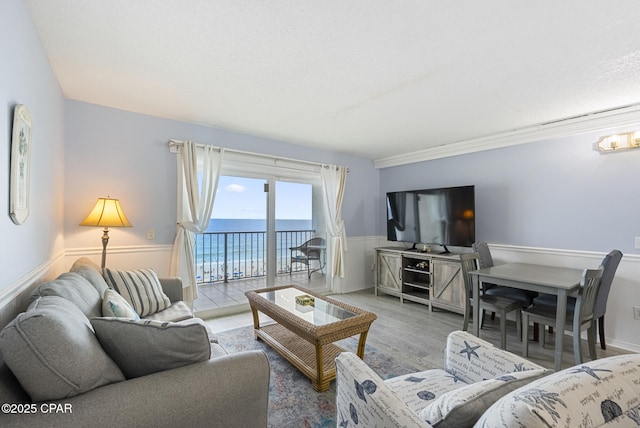8743 Thomas Dr Unit 928, Panama City Beach, FL 32408 - living room with wood finished floors and a wainscoted wall