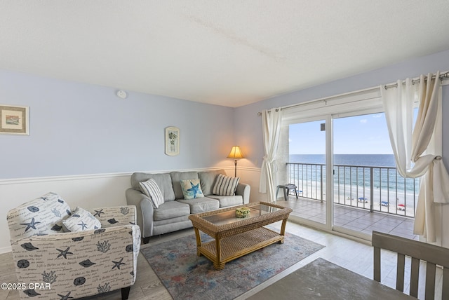 8743 Thomas Dr Unit 928, Panama City Beach, FL 32408 - living area with view of water and beach and wood finished floors