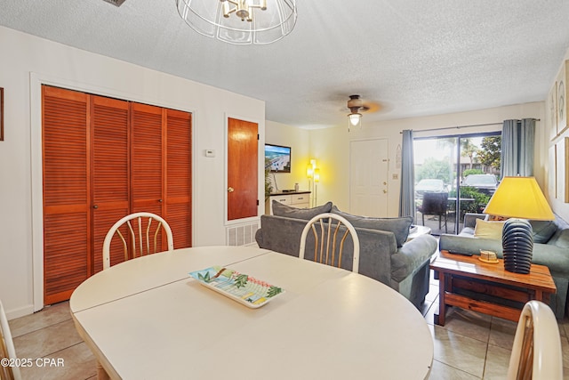 17620 Front Beach Rd Unit 4U, Panama City Beach, FL 32413 - dining area with a textured ceiling, light tile patterned floors, and a chandelier