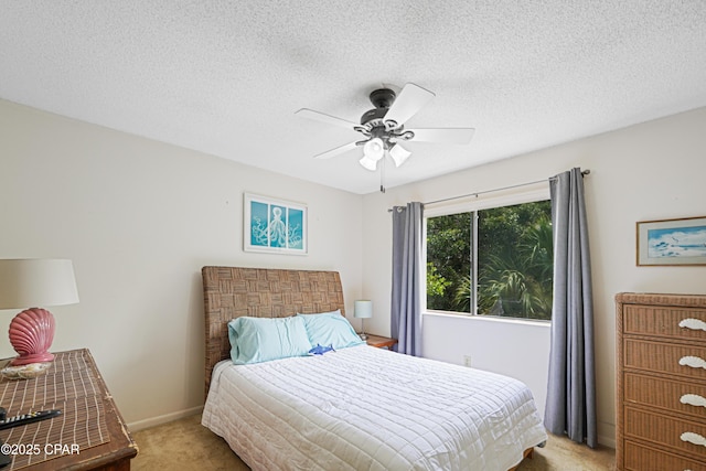 17620 Front Beach Rd Unit 4U, Panama City Beach, FL 32413 - bedroom with light colored carpet, a textured ceiling, and ceiling fan