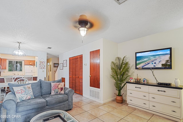 17620 Front Beach Rd Unit 4U, Panama City Beach, FL 32413 - living room with a textured ceiling, light tile patterned floors, and a ceiling fan