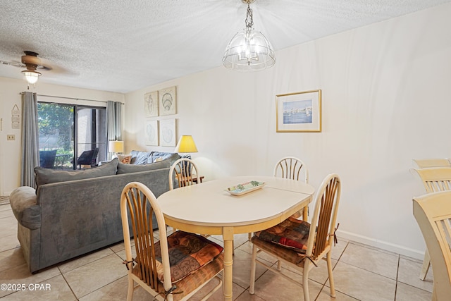 17620 Front Beach Rd Unit 4U, Panama City Beach, FL 32413 - dining area featuring a textured ceiling, light tile patterned floors, a chandelier, and a ceiling fan