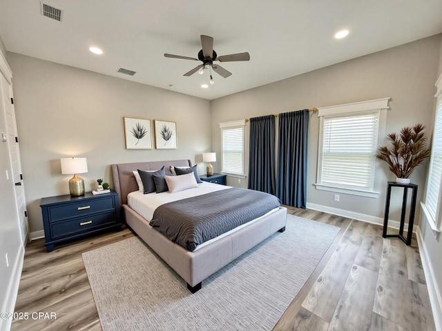 3391 Grey Oak Way, Marianna, FL 32446 - bedroom with multiple windows, light wood-style flooring, a ceiling fan, and recessed lighting
