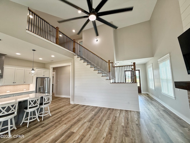 3391 Grey Oak Way, Marianna, FL 32446 - living room with a high ceiling, a ceiling fan, wood finished floors, recessed lighting, and stairway