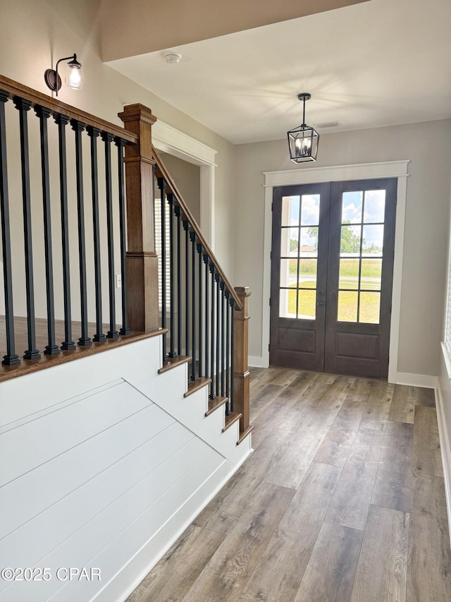 3391 Grey Oak Way, Marianna, FL 32446 - foyer featuring stairs, a chandelier, wood finished floors, and french doors