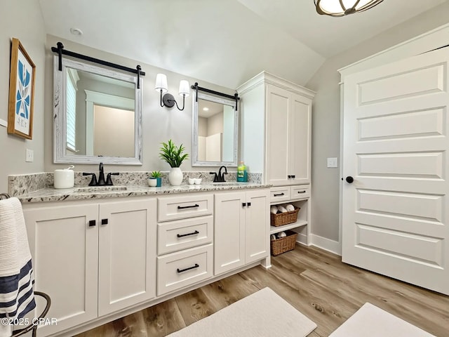 3391 Grey Oak Way, Marianna, FL 32446 - full bath with double vanity, wood finished floors, and vaulted ceiling