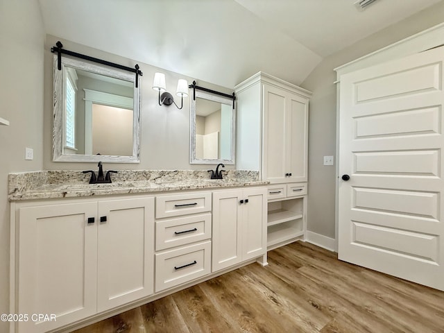 3391 Grey Oak Way, Marianna, FL 32446 - full bathroom with wood finished floors, vaulted ceiling, and double vanity
