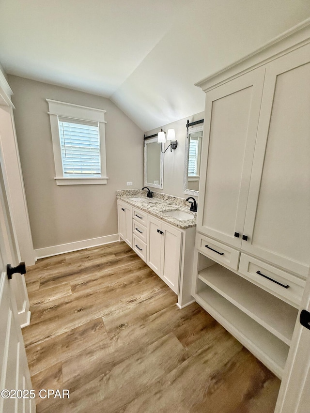 3391 Grey Oak Way, Marianna, FL 32446 - full bathroom with wood finished floors, vaulted ceiling, double vanity, and healthy amount of natural light