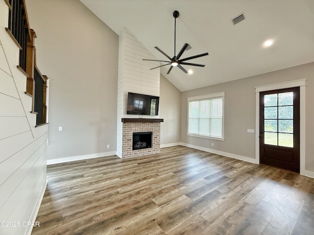 3391 Grey Oak Way, Marianna, FL 32446 - unfurnished living room featuring a ceiling fan, wood finished floors, high vaulted ceiling, a fireplace, and recessed lighting